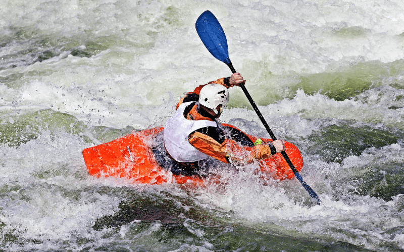 A kayaker navigating through rough waters, avoiding obstacles and using proper techniques to prevent injuries